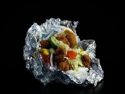 Rotating Falafel in Pita Bread With Fresh Vegetables Stock Footage 80411503