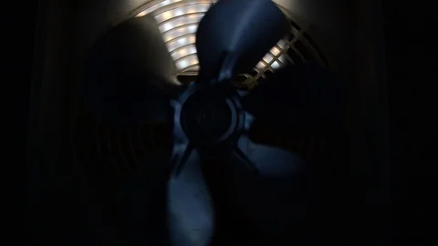 Rotating fan in the dark backlit at the back Stock Footage 107763651