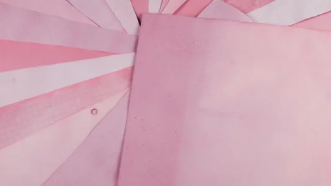 Rotating fan of handmade paper sheets dyed with natural vegetable colorants. 스톡 동영상 330274626