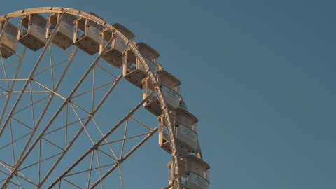 Rotating Ferris Wheel Against Clear Sky Stock Footage 321637543