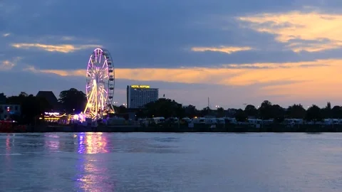 Rotating Ferris Wheel at the harbor Rostock at night - real time Stock Footage 140491987