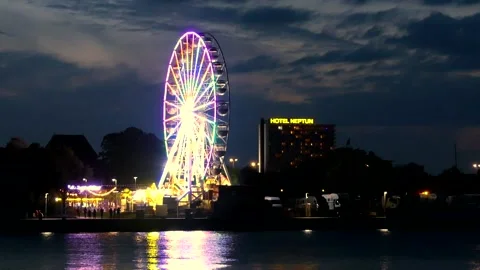 Rotating Ferris Wheel at the harbor Rostock at night - real time Stock Footage 140501801