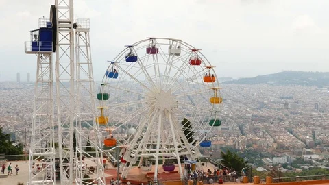 Rotating Ferris Wheel on Tibidabo mountain over Barcelona City Stock Footage 99358426