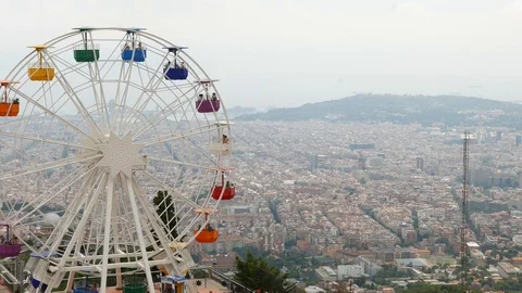 Rotating Ferris Wheel on Tibidabo mountain over Barcelona City Stock Footage 99497891