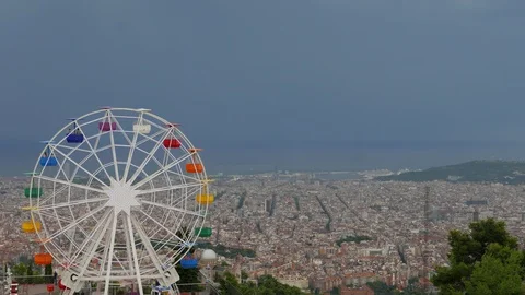 Rotating Ferris Wheel on Tibidabo mountain over Barcelona and dark sky Stock Footage 99887322