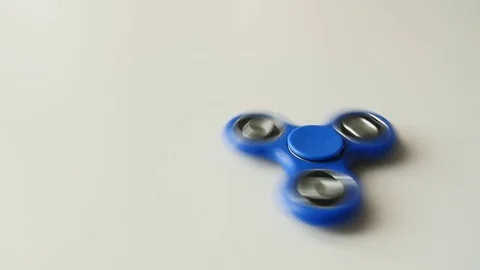 Rotating fidget spinner on a white background Stock Footage