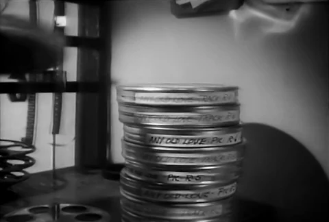 Rotating  film reels and stack of film cans, 1930s Stock Footage 90728476