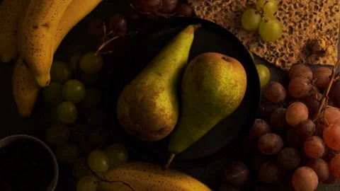 Rotating flatlay of pears on plate with grapes bananas coffee beans and cra.. Stock Footage 320567317