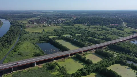 Rotating flight above highway bridge and river landscape Vidéo 321645712