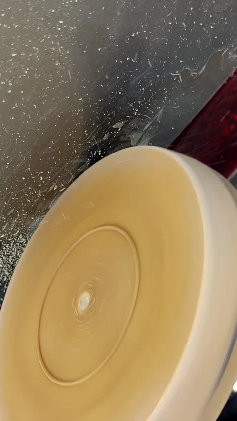 Rotating foam polishing pad buffing a car body at night Stock Footage 333702059