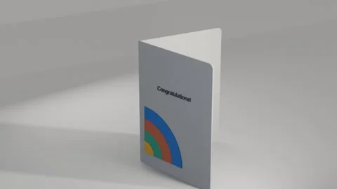 Rotating folded card opening after camera pan on table, revealing Stock Footage 339721885