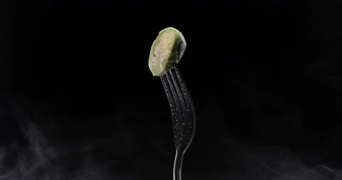 Rotating fork with cabbage on black background Stock Footage 144329392