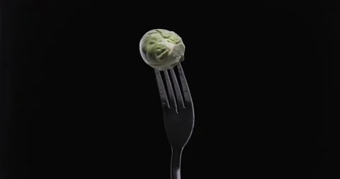 Rotating fork with cabbage on black background Stock Footage 145413512