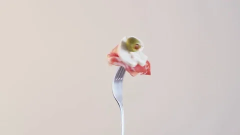 Rotating Fork With Ham and Button Mushroom on Almond Background Stock Footage 70541078
