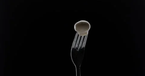 Rotating fork with olive on black background Stock Footage 144628720