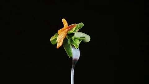 Rotating Fork With Salmon and Lettuce on Black Background Stock Footage 70539223