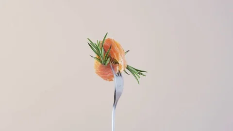 Rotating Fork With Salmon and Rosemary on Almond Background Stock Footage 70540568
