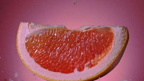 Rotating fresh grapefruit slice with sprinkling rock salt and raw sugar Stock Footage 142086682