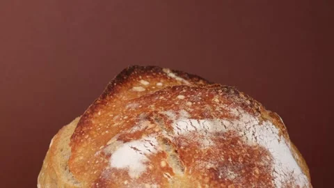 Rotating fresh homemade bread loaf with crispy golden crust and soft fluffy Stock Footage 311511527