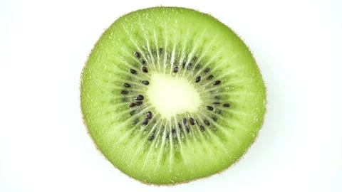 Rotating Fresh Kiwi Slice on a White Background. Stock-Footage 257662407