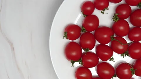 Rotating Fresh Red Cherry Tomatoes On A White Plate. Cherry Tomatoes Rotate On O Stock Footage 151271401