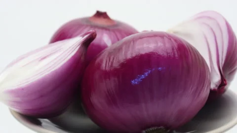 Rotating Fresh red onion in a plate Stock Footage 162644528