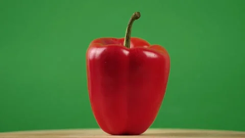 Rotating fresh sweet red pepper on a green background. Healthy eating concept Stock Footage 273832790