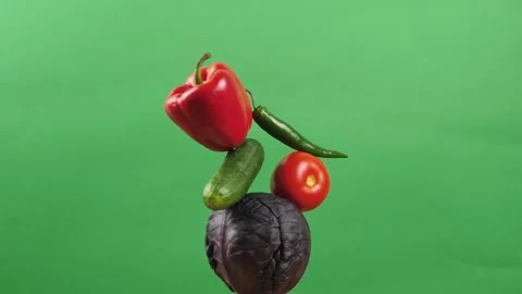 Rotating fresh vegetables on a green background. Creative food concept Stock Footage 249082199