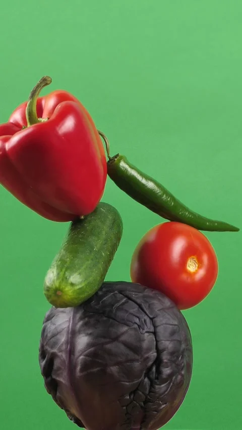 Rotating fresh vegetables on a green background. Creative food concept Stock Footage 308205852