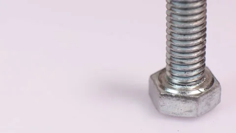 Rotating galvanized metallic screw close-up isolated on white background. Stock Footage 140616760