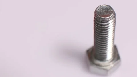 Rotating galvanized metallic screw close-up. Stainless steel bolt isolated Video stock 140971914