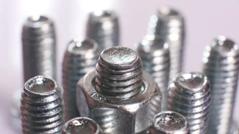 Rotating galvanized metallic screws close-up isolated on white background. Stock Footage 140616511