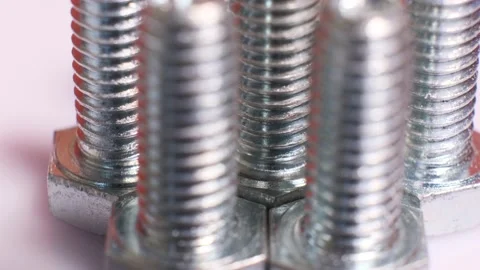 Rotating galvanized metallic screws close-up isolated on white background. Stock Footage 140676066