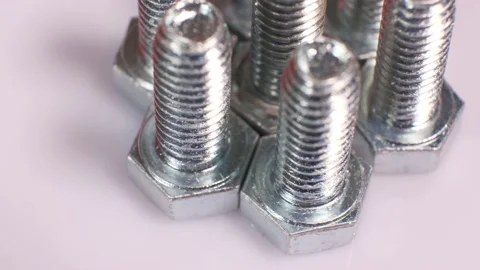 Rotating galvanized metallic screws close-up isolated on white background. Stock-Footage 140676126