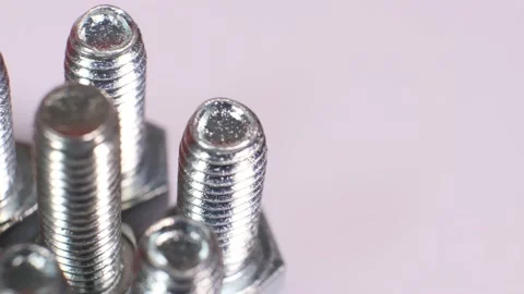 Rotating galvanized metallic screws close-up isolated on white background. Stock Footage 140676165