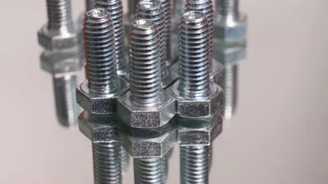 Rotating galvanized metallic screws close-up isolated on white background. Video stock 140704846