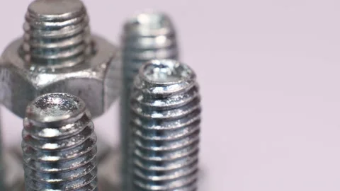 Rotating galvanized metallic screws close-up isolated on white background. Stock Footage 140741085