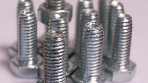 Rotating galvanized metallic screws close-up isolated on white background. Stock Footage 140876127