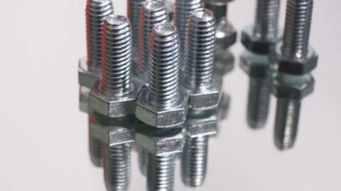 Rotating galvanized metallic screws close-up isolated on white background. Stock Footage 141107808