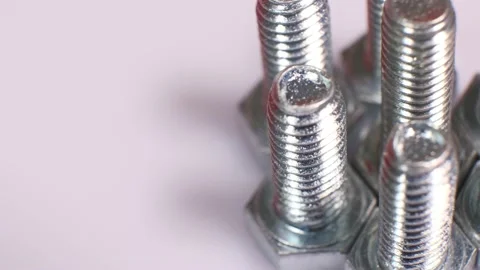 Rotating galvanized metallic screws close-up isolated on white background. Stock Footage 141108086