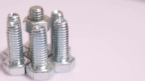 Rotating galvanized metallic screws close-up isolated on white background. Stock Footage 141187218