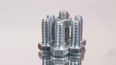 Rotating galvanized metallic screws close-up isolated on white background. Stock Footage 141382961