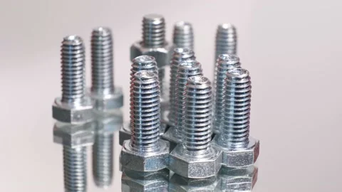 Rotating galvanized metallic screws close-up isolated on white background. Stock Footage 141440645