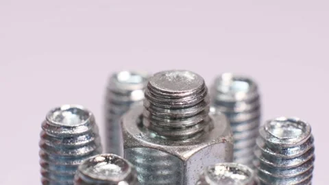 Rotating galvanized metallic screws close-up isolated on white background. Stock Footage 141441146