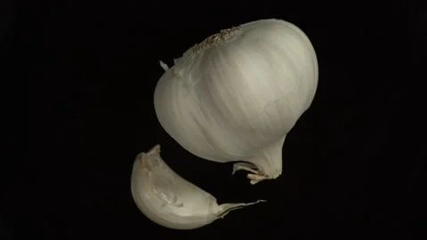 Rotating garlic on a black background Stock Footage 208820840