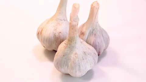 Rotating garlic head on wite background. Stock Footage 165475023