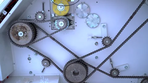 Rotating gears and chains inside an industrial machine powering Stock Footage 341555370