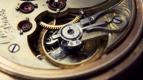 Rotating gears inside a vintage watch mechanism Stock Footage 153056293