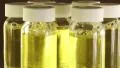 Rotating glass bottles with foamed yellow liquid HD Footage