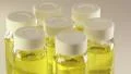 Rotating glass bottles with yellow liquid HD Footage